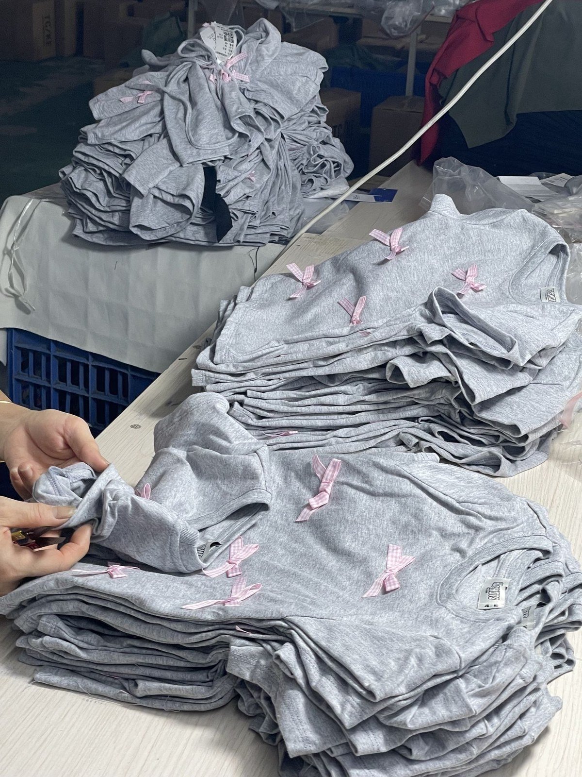 Garments being handled individually at a worktable