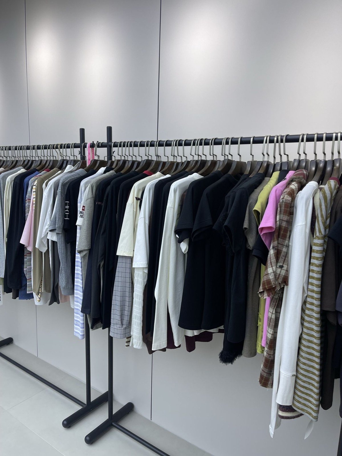 Different garment styles on a sample rail